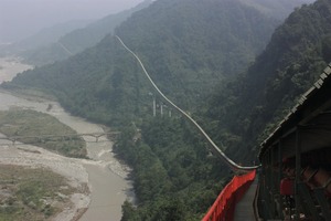 Belt conveying systems enable rapid and efficient transport of bulk material from the quarry to the destination as well as through rough terrain while simultaneously protecting the environment from falling material