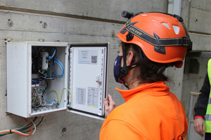 1 Ramona Keller, Head of Maintenance at Jura-Cement-Fabriken AG, checking the IoT box which sends the collected data via a mobile connection to the Premas® Cloud